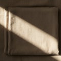 Beige fabric folded neatly, casting a diagonal shadow across its surface. The texture Royalty Free Stock Photo