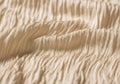 Beige fabric with a textured, wrinkled surface is shown in close- Royalty Free Stock Photo