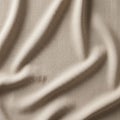 Beige fabric with visible texture and subtle shadows. Light Royalty Free Stock Photo