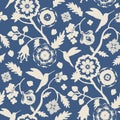 Beige flowers and hummingbirds silhouettes seamless pattern on blue background. Indian floral style pattern Royalty Free Stock Photo
