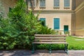 Beige garden bench at public park at summer time