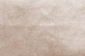 Beige gold velvet background or velour flannel texture made of cotton or wool with soft fluffy velvety satin fabric