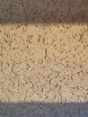 Beige golden wallpaper with a wooden cork coating with a pronounced texture Royalty Free Stock Photo