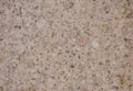Beige granite, a flat surface of a naural light stone with dark inclusions close-up Royalty Free Stock Photo