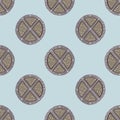 Beige and grey colored wood shield seamless pattern. Circle weapon ornament on light blue background Royalty Free Stock Photo