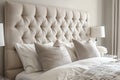 Beige headboard of double bed with tufted upholstery, decorated button-tufted backrest, bedside table, white lamp Royalty Free Stock Photo