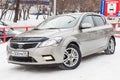 Beige Kia Ceed front view on the car parking with snow background in the street Royalty Free Stock Photo