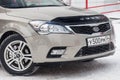 Beige Kia Ceed front view on the car parking with snow background in the street Royalty Free Stock Photo