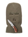 Beige knitted balaclava and knife on white background, top view Royalty Free Stock Photo