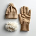 Beige Knitted Hat Glove and White Pom Pom on White Background Royalty Free Stock Photo
