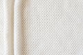 Beige knitted woolen background. Knitwear fabric texture Royalty Free Stock Photo