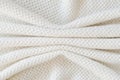 Beige knitted woolen background. Knitwear fabric texture. Royalty Free Stock Photo