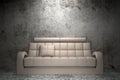 Beige leather sofa in front of grunge wall
