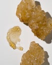 on a beige light background in the center of the frame, a sample smear of a transparent yellow cosmetic moisturizing gel