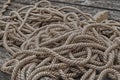 Beige long ropes stacked in heaps of sea tackle