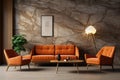 Beige lounge chair near orange loveseat sofa against wood and stone paneling wall. Mid-century style home interior design
