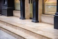 Beige marble threshold with steps at entrance to glass door. Royalty Free Stock Photo