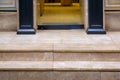 Beige marble threshold with steps at the entrance to the glass door. Royalty Free Stock Photo