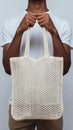 Eco-Friendly Beige Mesh Tote Bag Held in Hands on Minimal Background â Sustainable Reusable Shopping Bag Concept Royalty Free Stock Photo