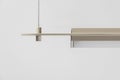 Beige metal lamp hanging on gray wall background in studio