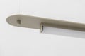 Beige metal lamp hanging on gray wall background in studio