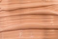 Beige nude liquid foundation texture, concealer smear smudge drop. Closeup macro. Cosmetic tonal makeup moisturizer, bb cream