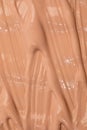 Beige nude liquid foundation texture, concealer smear smudge drop. Closeup macro. Cosmetic tonal makeup moisturizer, bb cream