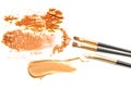 Beige and orange crushed eyeshadow and makeup brush isolated on white background. Royalty Free Stock Photo