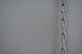 On beige painted wall beige chain Royalty Free Stock Photo