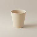 A beige paper cup is centered on a light, neutral background. The cup has a simple Royalty Free Stock Photo
