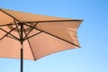 Beige parasol on a blue sky