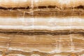 Beige patterned onyx close-up, natural stone backgorund.