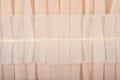 Beige pleated transparent caprone cloth as background texture