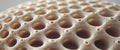 Beige Porous Object with Repeating Round Holes Close up. Royalty Free Stock Photo