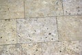 Beige porous stone sidewalk pavment of rectangular shape tiles. Royalty Free Stock Photo