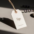 A beige, rectangular paper tag with the text \