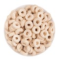 Beige rings corn flakes in white bowl isolated, top view. Cereals. Royalty Free Stock Photo