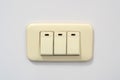 Beige rocker light switch with three buttons Royalty Free Stock Photo
