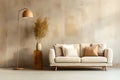 Beige rustic sofa and floor lamp against concrete wall with copy space.