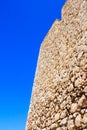 Beige sandstone wall with blue sky