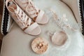 Beige shoes for the bride, wedding rings, perfume, garter. Royalty Free Stock Photo