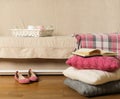 Beige sofa with plaid and colorful pillows pink, grey, white a