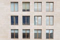 Beige stone wall with many windows Royalty Free Stock Photo
