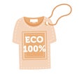 Beige T-shirt with eco 100 label attached, sustainable clothing concept. Eco-friendly apparel promotion, organic cotton Royalty Free Stock Photo