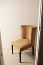 Beige/tan chair in hallway