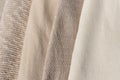 Beige, taupe, light brown, creamy wool, cotton and cashmere blend knitted sweaters texture stack together. Warm neutral color Royalty Free Stock Photo