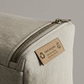 Beige textile bag featuring a top zipper with a metallic pull tab. The fabric has a Royalty Free Stock Photo