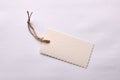 Beige textured paper tag tied with string