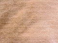 Beige textured surface resembling a plush towel.