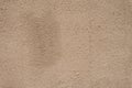 Beige textured wall, background. Structural plaster coated with water-based acrylic paint. Rough, uneven surface beige